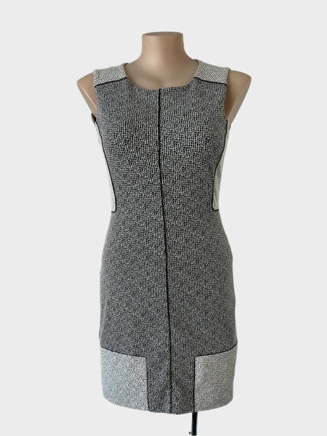 Veronika Maine sleeveless shift dress in jersey with black & white crackle print, piped trim, and contrasting back panels for office wear.