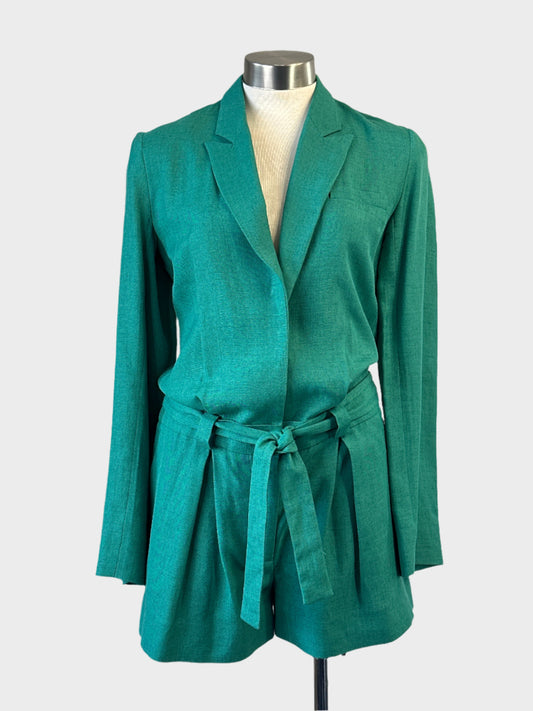 Designer Victoria Beckham playsuit in green linen with long sleeves, pleated leg and sash tie.