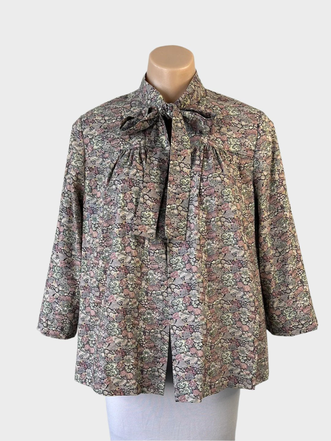 Vintage 60s open front jacket in mauve Liberty floral print, featuring a band collar with pussy bow, three-quarter sleeves, and gathered yoke for smart casual.