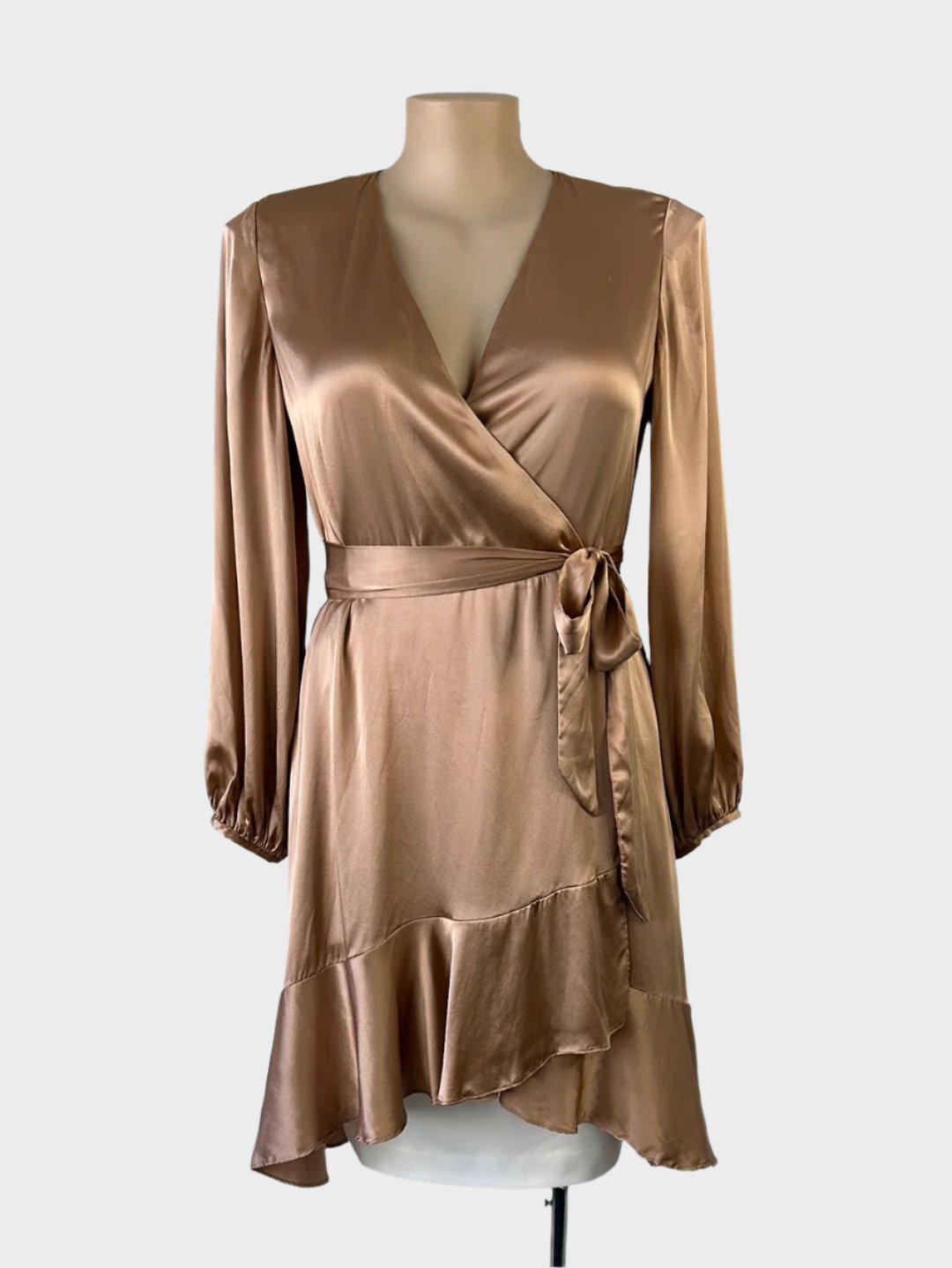 Witchery wrap dress in copper satin with surplice neck, long sleeves, waist sash, and tulip skirt with flounce hem for evening wear.