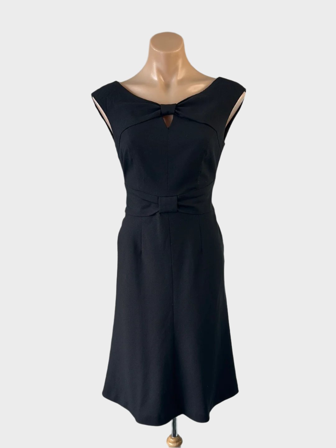 Designer Ann Klein sleeveless A-line dress in black with keyhole neck, loop knot waistband and flared skirt for office or evening wear.