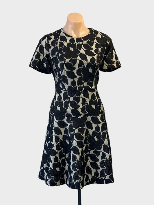 Designer Ann Taylor A-line dress in beige and black with floral appliqué and flared skirt for office or evening wear.