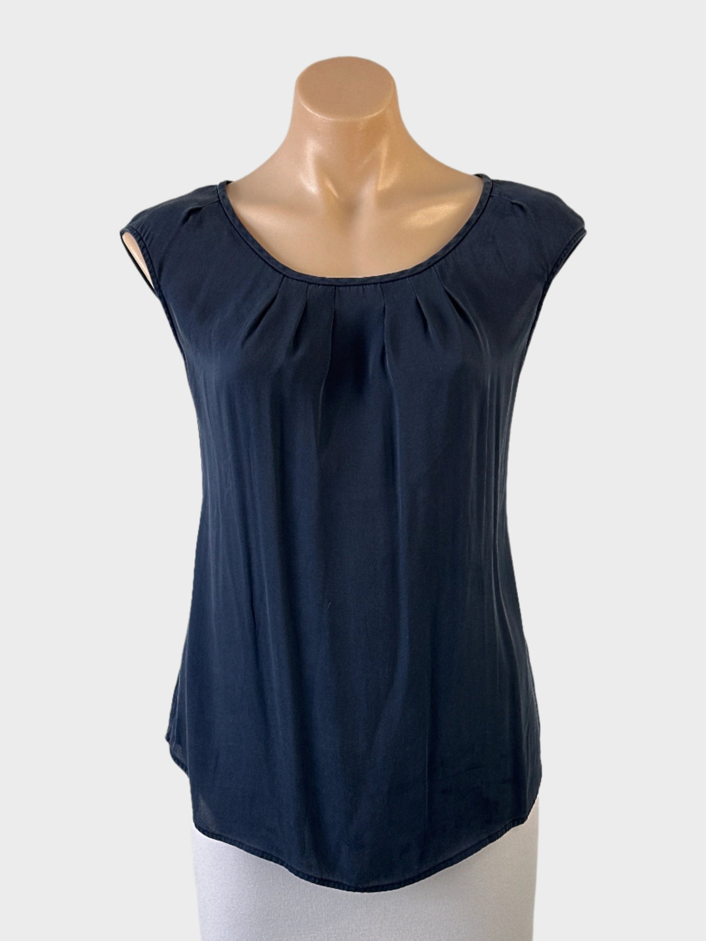 Designer Anna Thomas sleeveless top in grey with sunburst neck, keyhole back and curved hem for office wear.