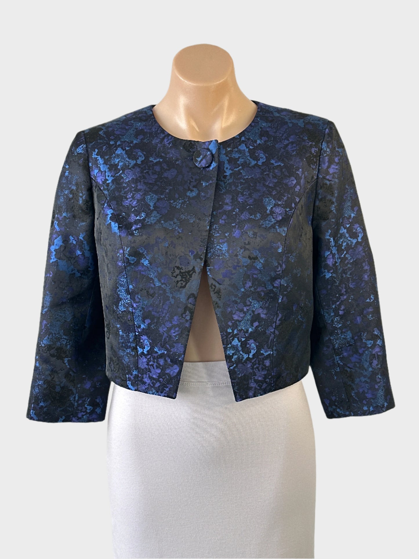 Designer Anthea Crawford cropped cardigan jacket in blue satin jacquard with single button closure and three quarter sleeves for evening or office wear.