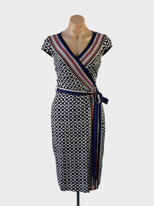 Designer Anthea Crawford sheath dress in blue jersey with ogee pattern, cap sleeves, surplice neck, contrasting sash tie and tulip skirt for office or events.