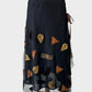 Asymmetric skirt in sheer mesh with satin and velvet appliqué, embroidery, beading, ruched hip and slanted hem.