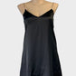 Atmos & Here slip dress in black with v-neck and flared skirt for evening or formal wear.