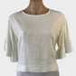 Ava top in white slub weave with round neck, ruffle cuffs and notched hip band for office or smart casual.