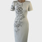 Designer Badgley Mischka sheath dress in white scuba fabric with laser cut butterfly motifs, round neck and pencil skirt for special events.