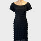 Bang tube dress in black with ruffle trim and layered tiers for evening or formal wear.