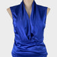 Basque blue satin finish sleeveless top with plunge v-neck, shawl collar, and yoke hip band for evening or formal wear.