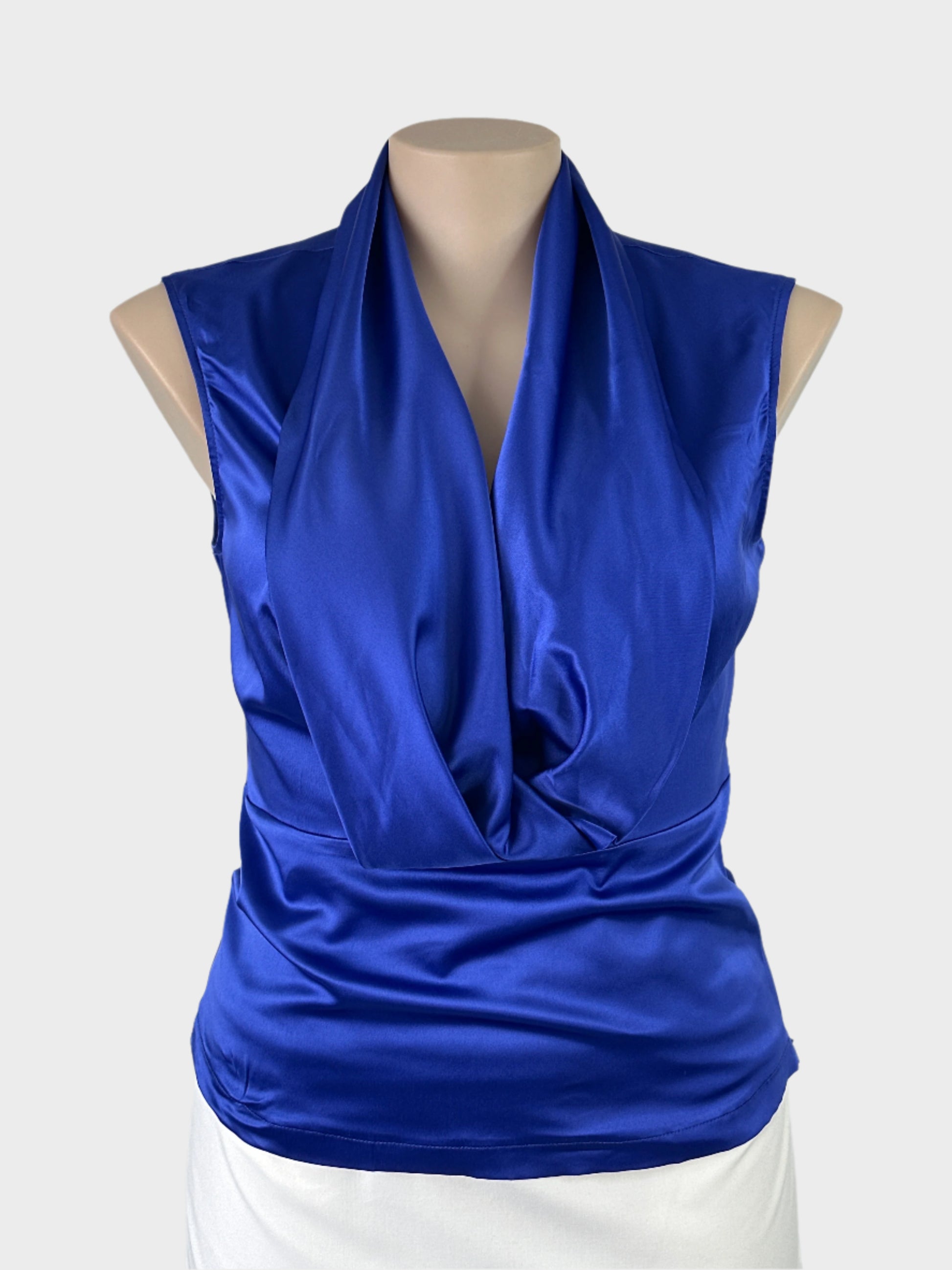 Basque blue satin finish sleeveless top with plunge v-neck, shawl collar, and yoke hip band for evening or formal wear.