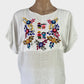 Boho style top in white sheer check weave with multicoloured embroidery and folk art motifs for smart casual wear