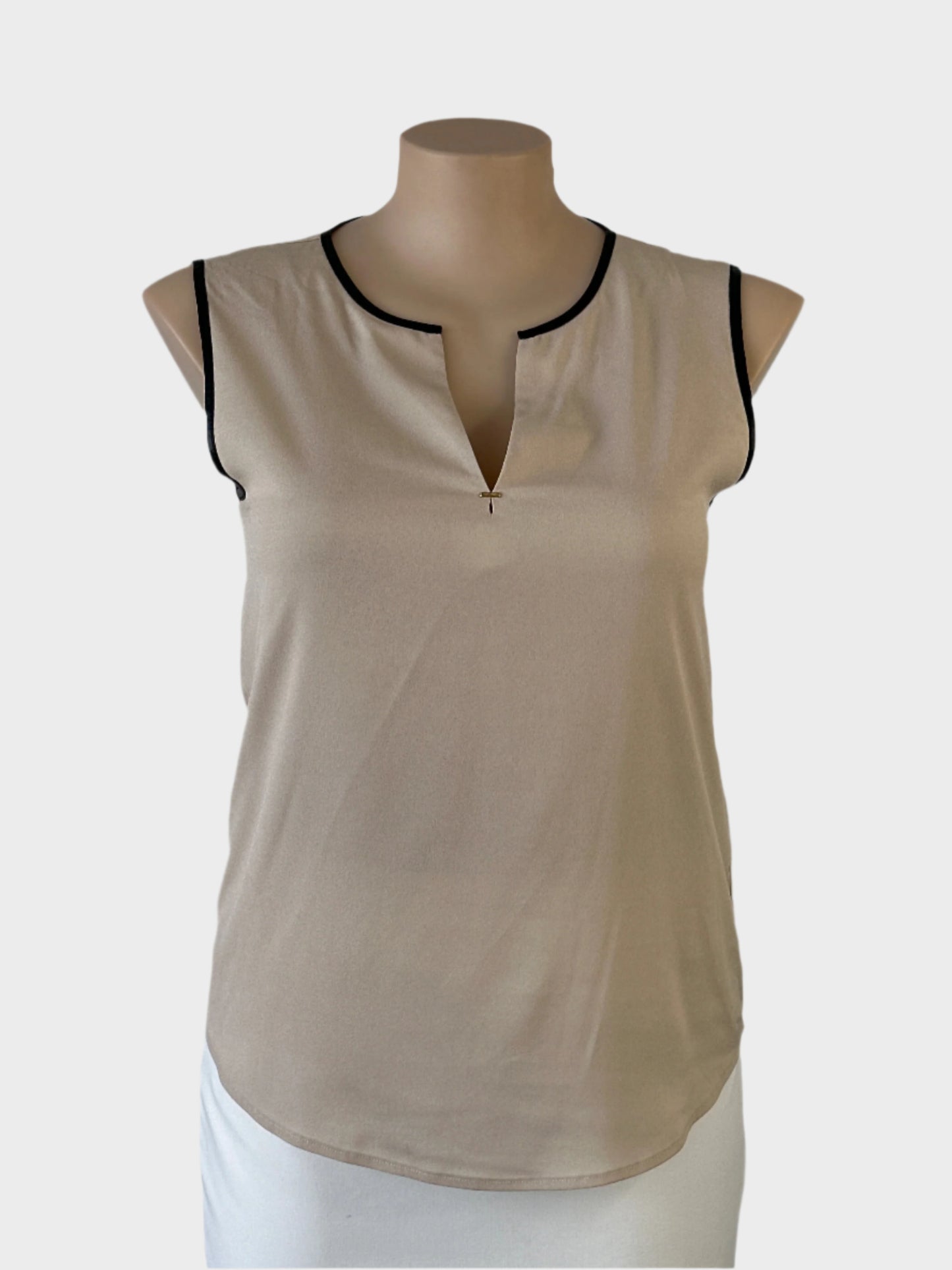 Designer Calvin Klein sleeveless top in beige with contrasting black trim, notched neck and curved hem for office wear.