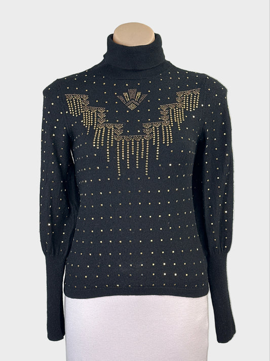 Designer Camilla black wool sweater with applique studded front panel, ribbed turtleneck and barrel cuffs for evening or office wear.