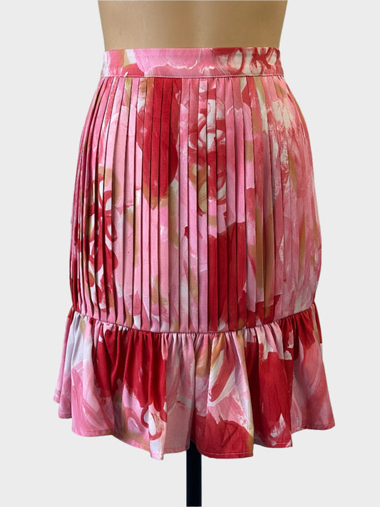 Designer Casper + Pearl mini skirt in pink floral print with pleats and ruffle hem for smart casual wear.