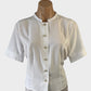 Designer Anna Braun white shirt with mother of pearl buttons, band collar, and short sleeves with banded cuffs for office or smart casual wear.