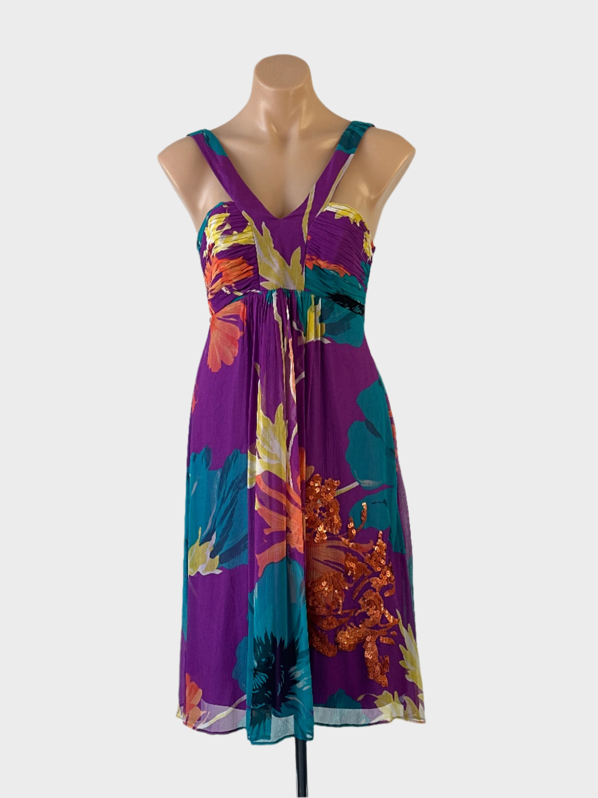 Coast sleeveless dress in multicoloured sheer silk crepe with bright floral print, ruched bodice and flared skirt for resort or smart casual wear.