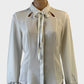 Cue ivory shirt in crepe with keyhole neckline, string tie and long raglan sleeves for office wear.