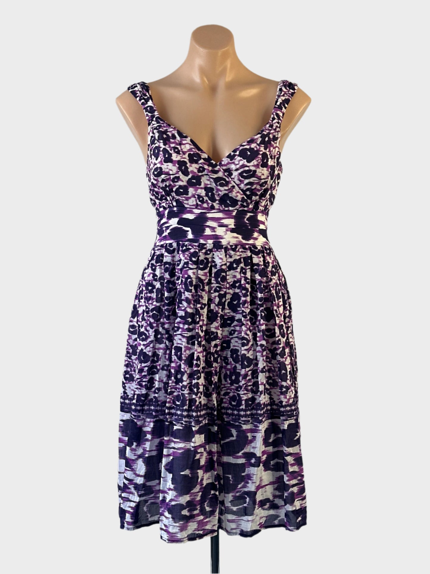 David Lawrence sleeveless A-line dress in purple cotton silk blend with ikat floral print, surplice neck and pleated skirt for smart casual or resort wear.