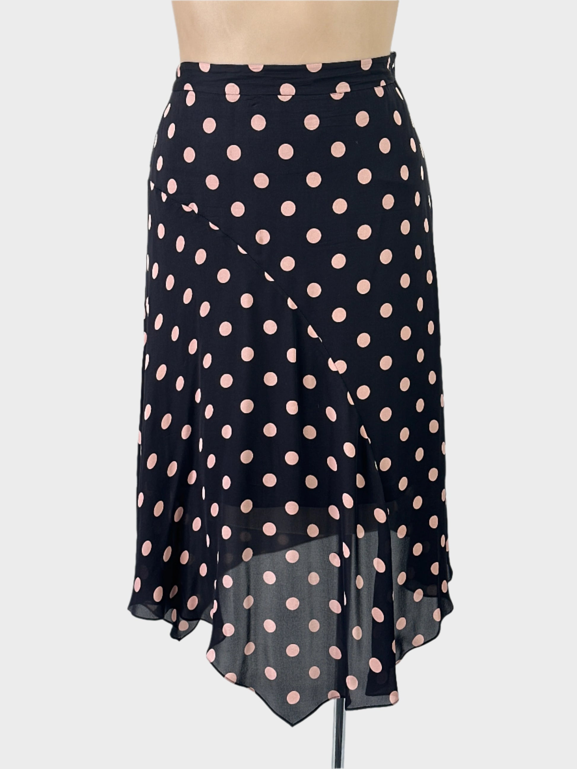 David Lawrence black and pink flared panel skirt in sheer fabric with polka dot print and handkerchief hem for office wear.