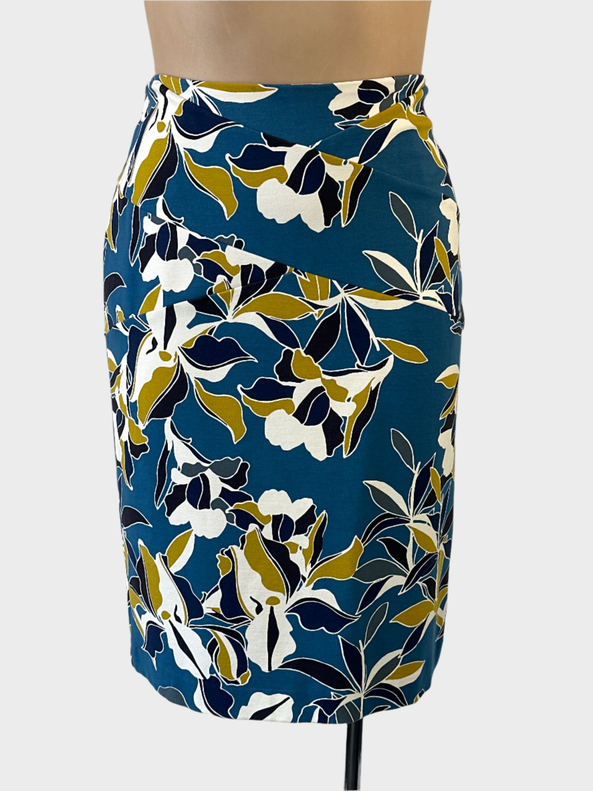 David Lawrence straight skirt in green with floral print, overlapping diagonal panels and back vent for office wear.