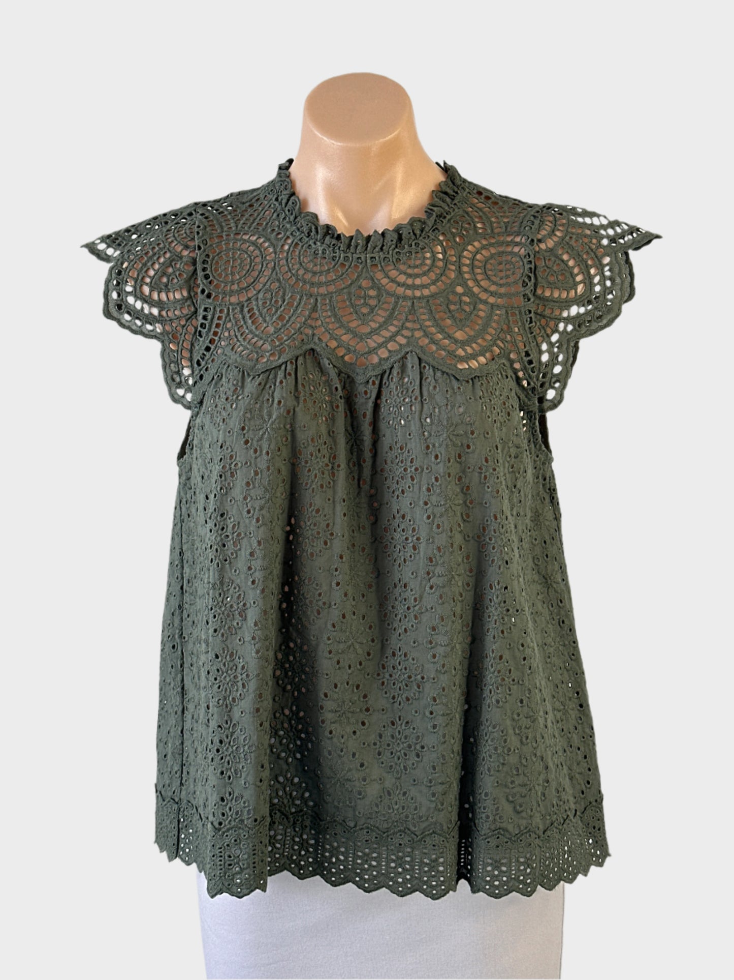 Decjuba top in green guipure lace with sheer yoke, frilled round neck, cap sleeves and keyhole back for smart casual wear.