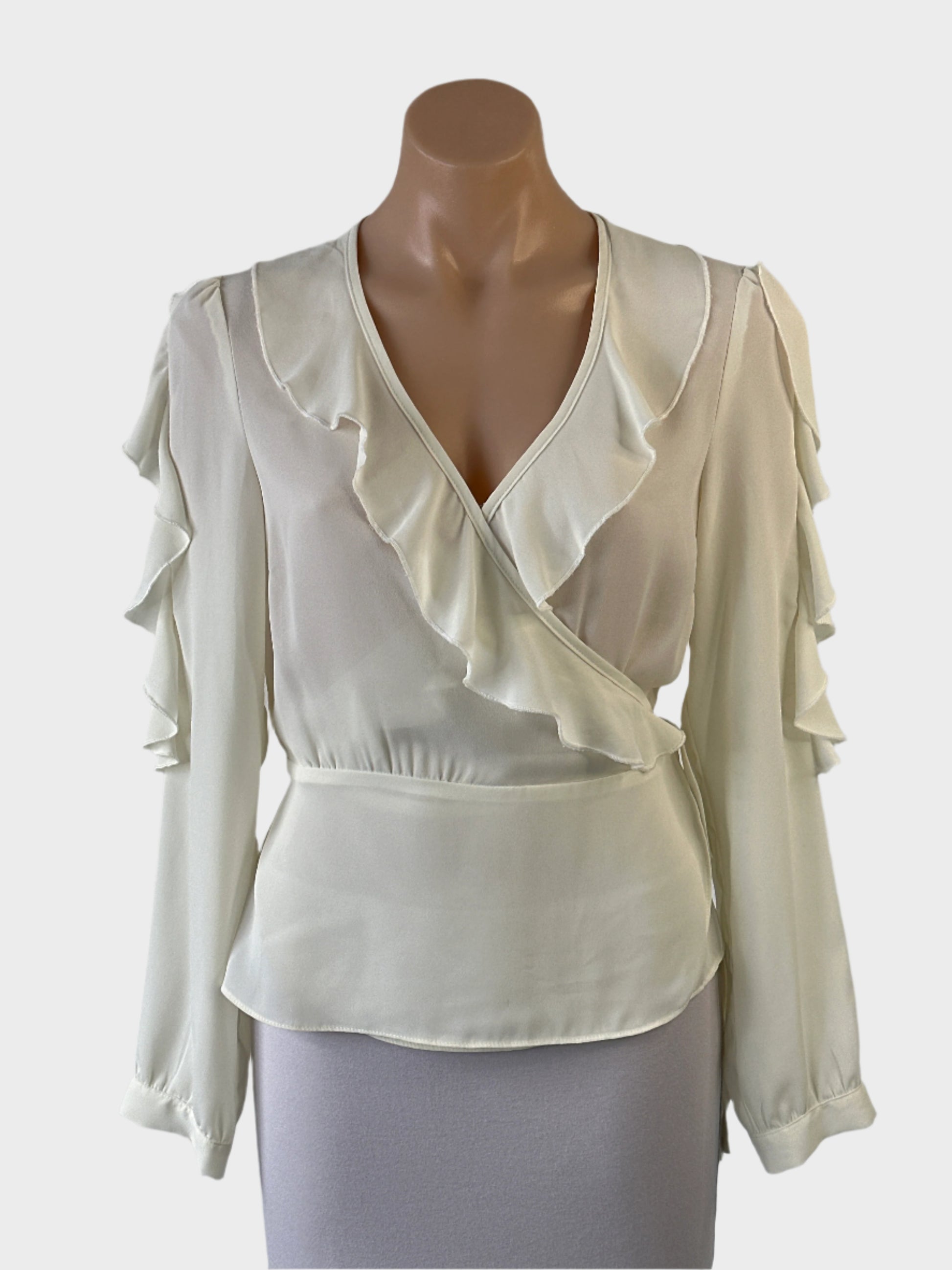 Designer Alannah Hill peplum top in white sheer crepe with tie closure, flounce trim and long sleeves for office or special events.