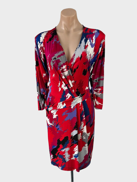 Designer BCBG Max Azria red drop waist dress in jersey with bright brushstroke pattern and pleated skirt for office wear