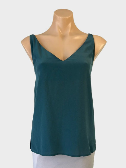 Designer Ginia sleeveless camisole top in green silk with v-neck, spaghetti straps, and notched hem for office or evening wear.