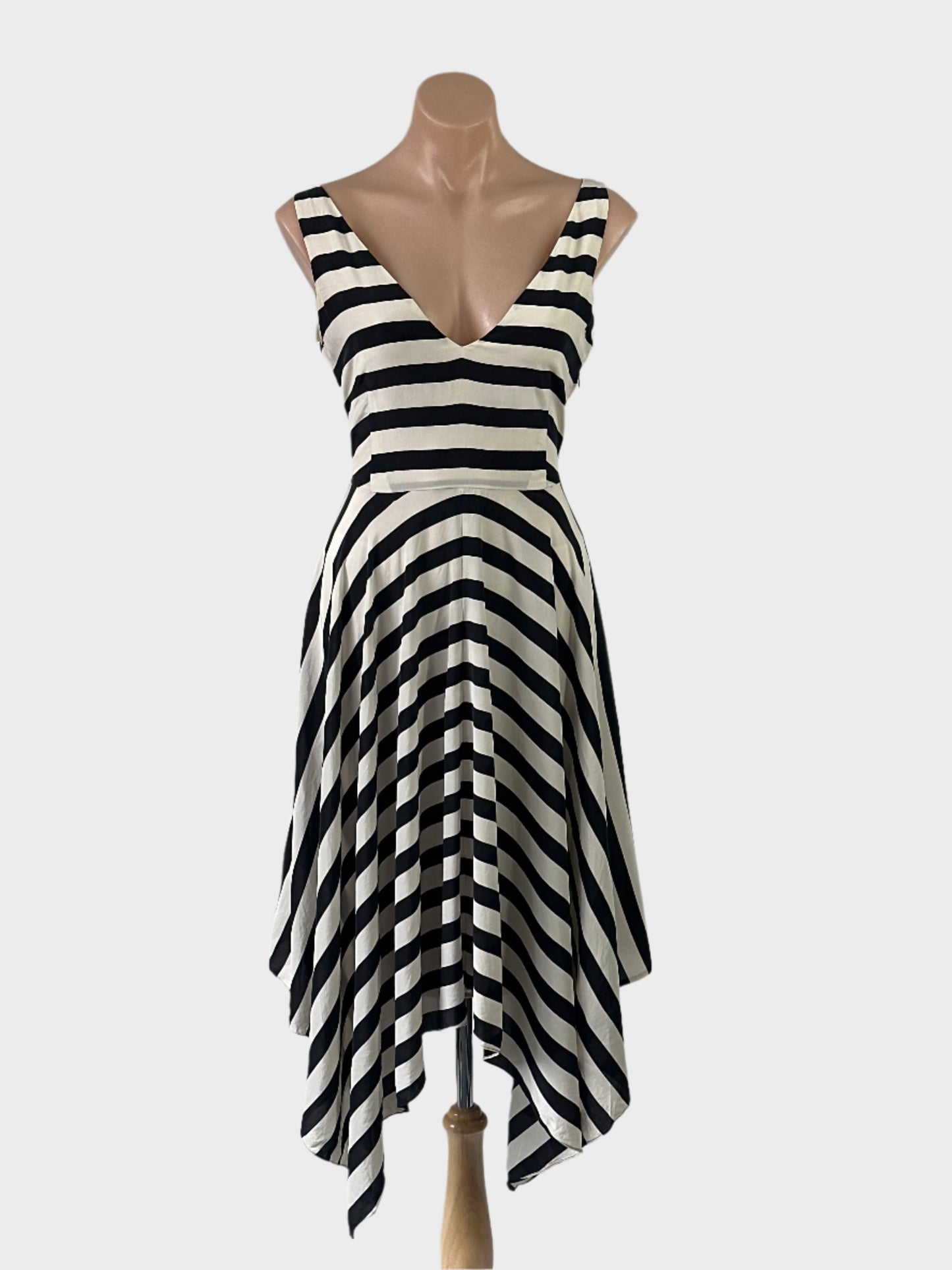 Designer Luxe Deluxe black and white A-line dress in silk with cabana stripes, v-neck, and handkerchief hem for special events or evening wear.