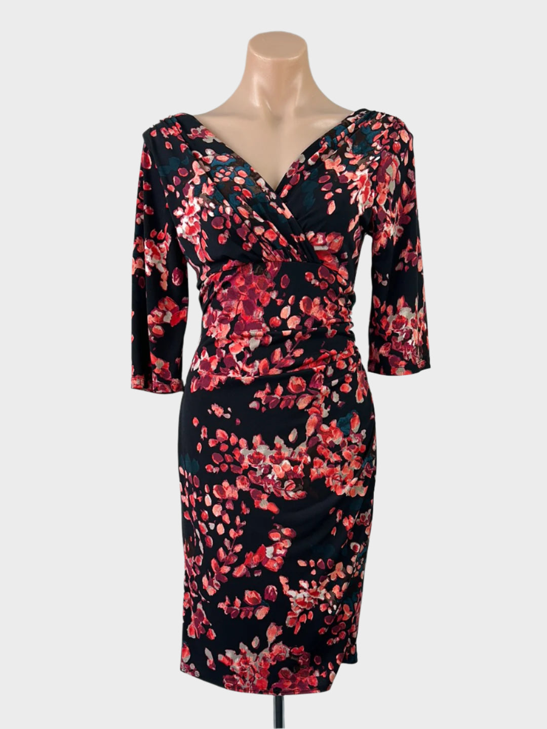 Designer Rebecca Ruby black and pink empire waist dress in dark floral jersey with surplice neck and tulip skirt for office wear.