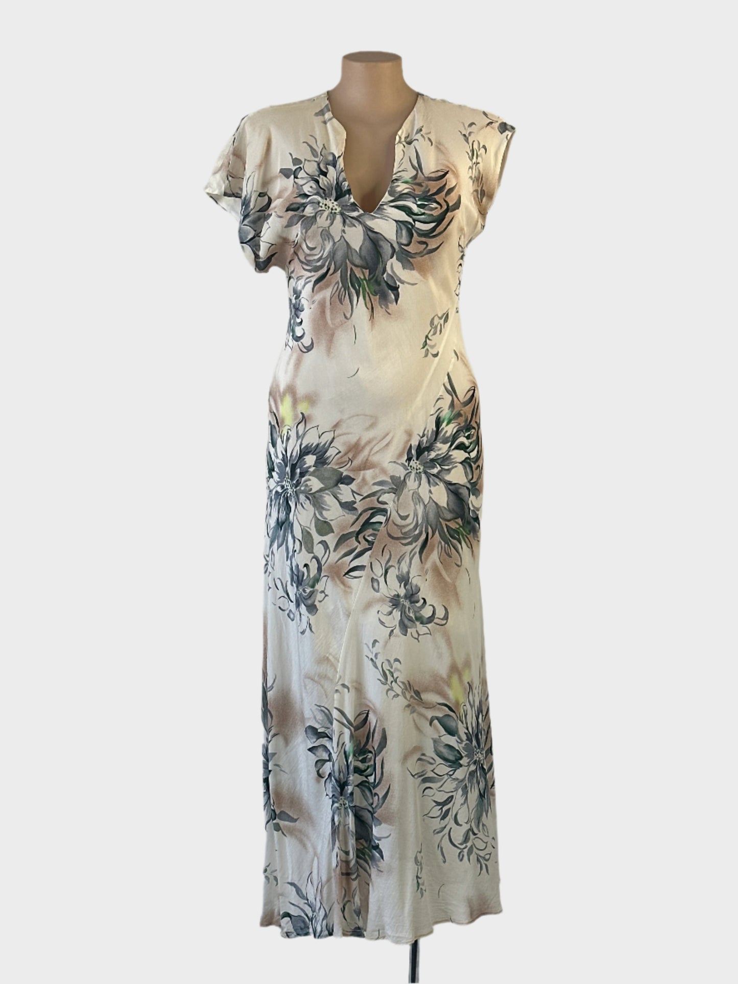 Designer white asymmetric bias cut gown with floral print, notched neck, and slanted hem for special events or evening wear.