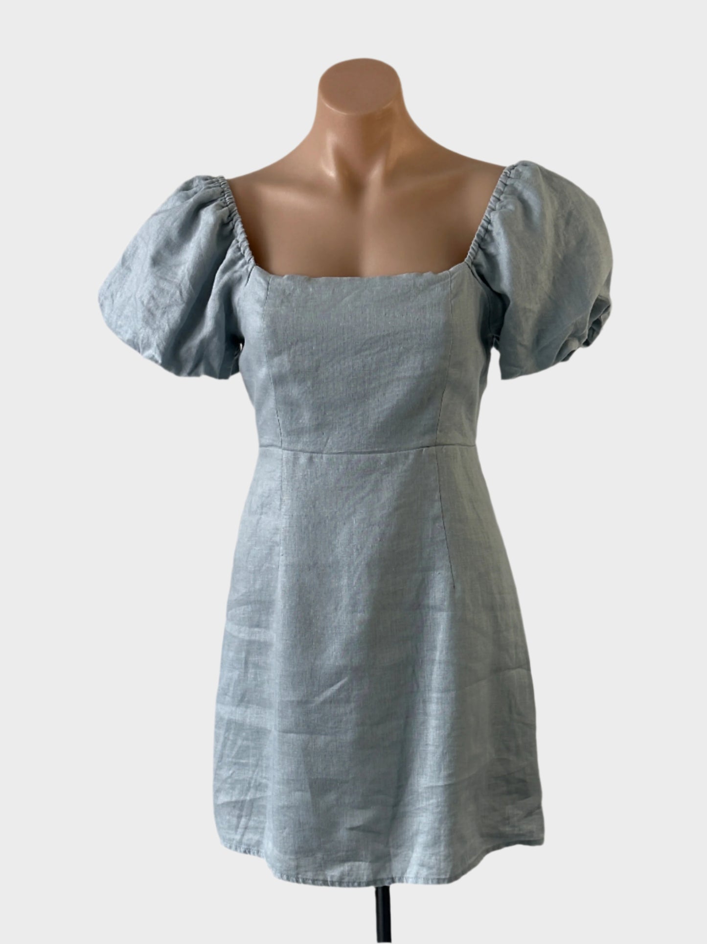 Designer DISSH off the shoulder dress in blue linen with puff sleeves, shirred back and flared skirt for smart casual wear.