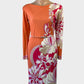 Designer Emilio Pucci knee length dress in orange with a floral print, bateau neck and skinny belt for office or special events.
