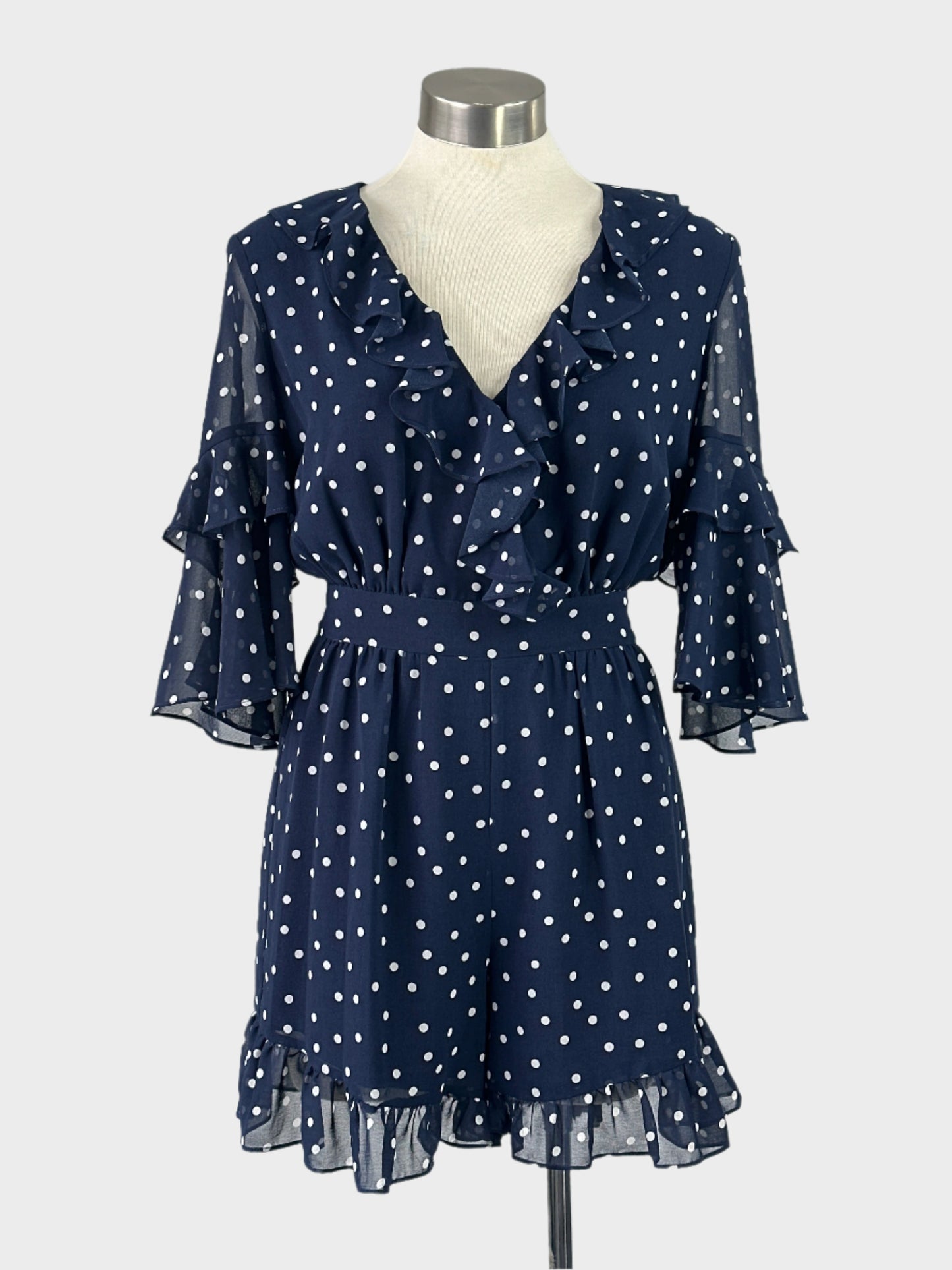 Forever New blue and white playsuit in sheer crepe with polka dot print, ruffle trim, and flared legs for smart casual wear.