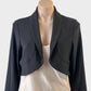 Designer Frank Lyman bolero jacket in black jersey with bow detail and shawl lapels for evening or formal wear.