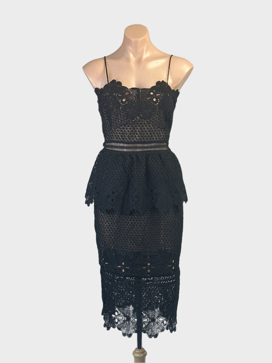 Designer Grace & Hart black guipure lace sleeveless sheath dress with sweetheart neck, peplum waist and pencil skirt for evening or formal wear.