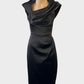 Designer Karen Millen sheath dress in black with satin finish, asymmetric neck, draped bodice and pencil skirt for evening or formal wear.