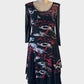 Designer L'Officiel New Zealand black and red drop waist dress with mesh overlay and flared crinkle skirt for evening wear.