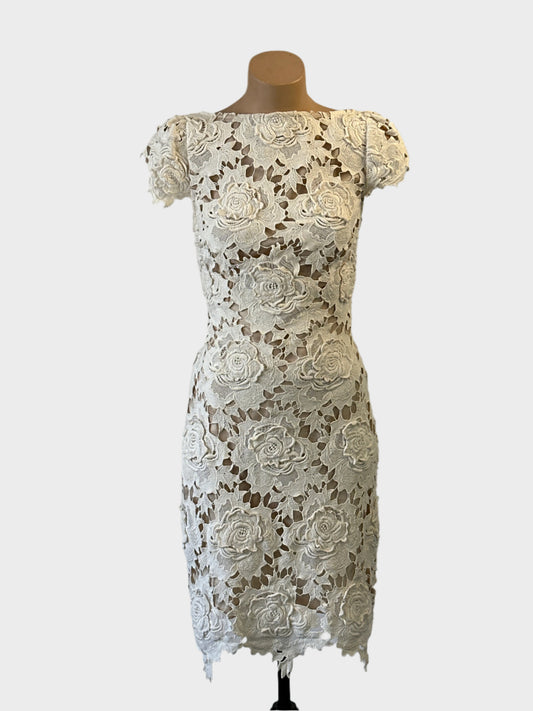 Designer Lover sheath dress in white with appliqué rosettes and scallop edging for special events wear.