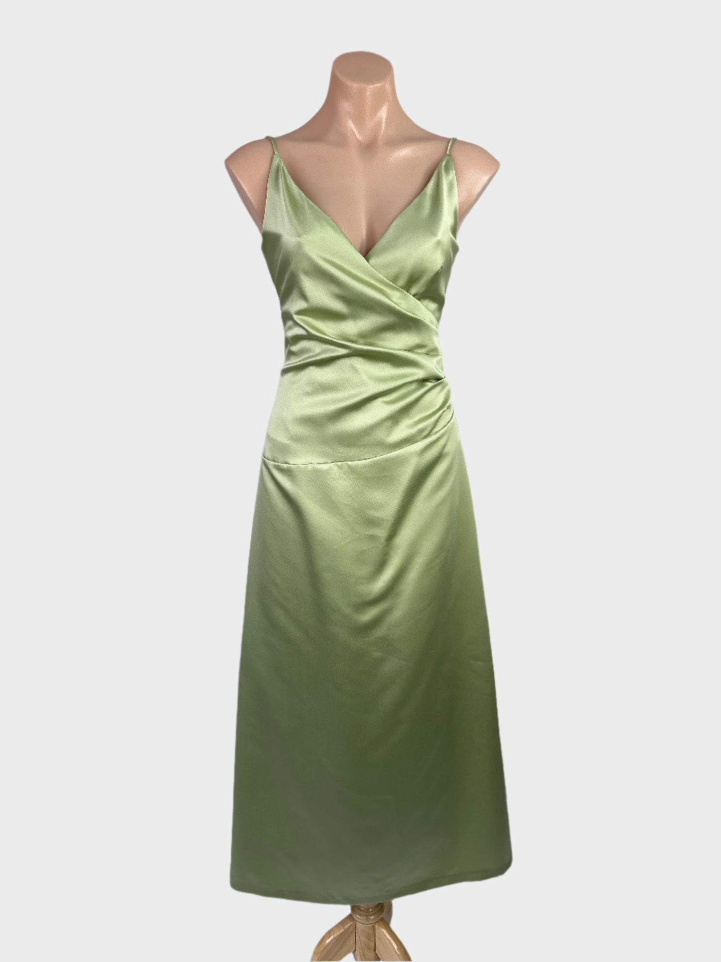 Monica green sleeveless dress in satin finish with surplice neck, spaghetti straps and pleated ruched waist for formal wear.