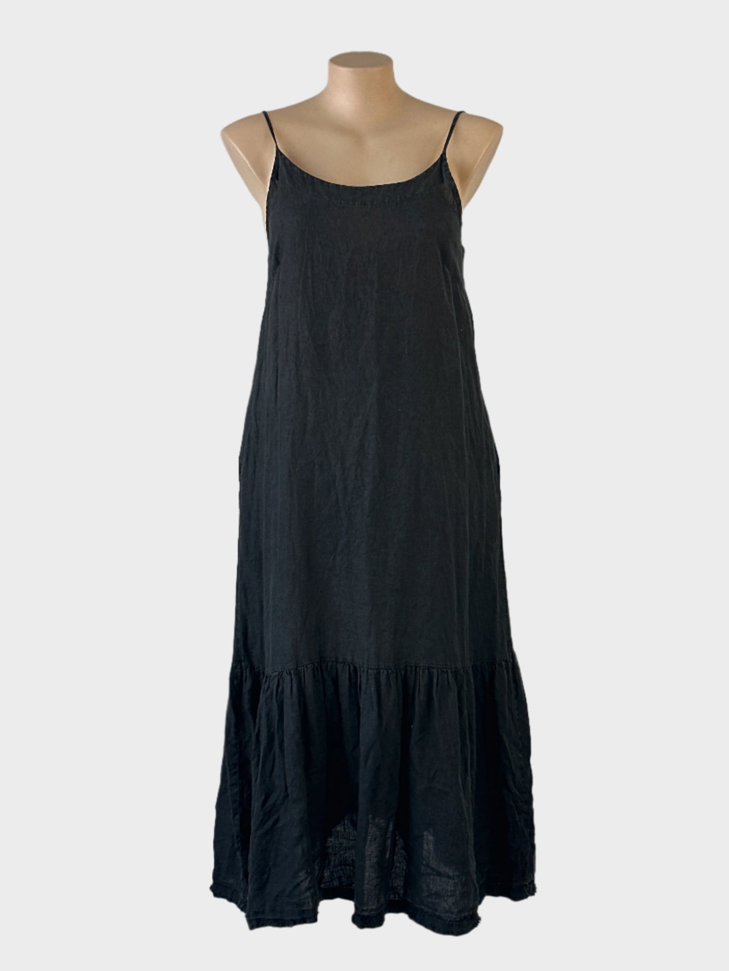 Designer Montaigne Paris peasant dress in black pure linen with scoop neck, spaghetti straps and tiered skirt for smart casual wear.