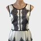 Designer Moss & Spy peplum top in black and white with lace inserts and satin finish for special events or office wear.
