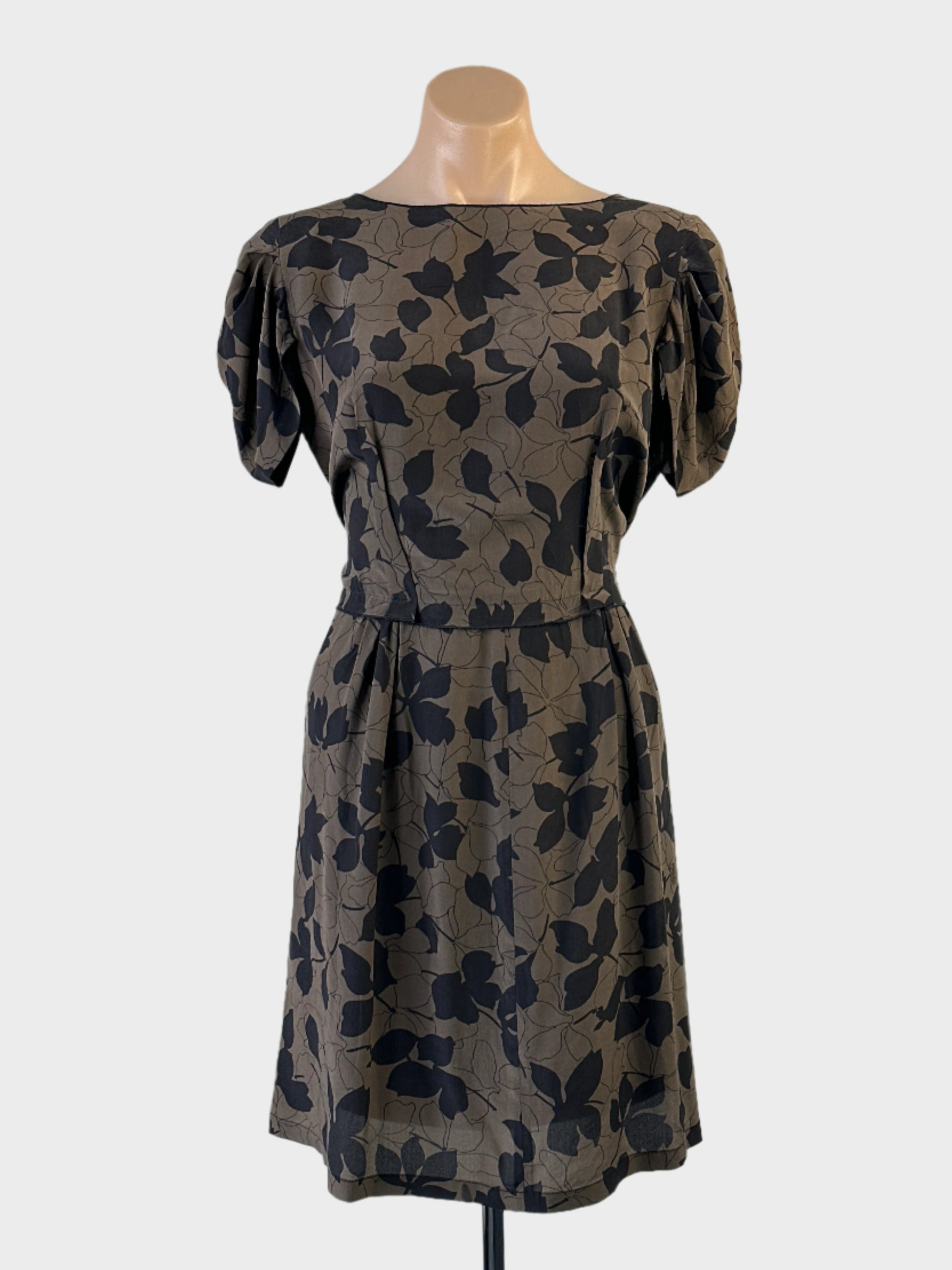 Designer Nina Ricci sheath dress in brown and black botanical print silk with pleated cap sleeves, bateau neck and pleated waist for office or events.