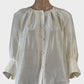 Designer Oroton Poet shirt in pure silk featuring a button front with covered buttons, round pleated neck, three quarter raglan sleeves with notched cuffs.
