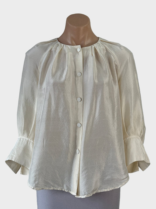 Designer Oroton Poet shirt in pure silk featuring a button front with covered buttons, round pleated neck, three quarter raglan sleeves with notched cuffs.