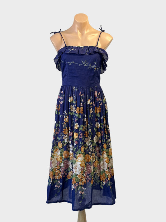 Paul Collins vintage 70's sleeveless A-line dress in blue and orange floral print for smart casual wear.