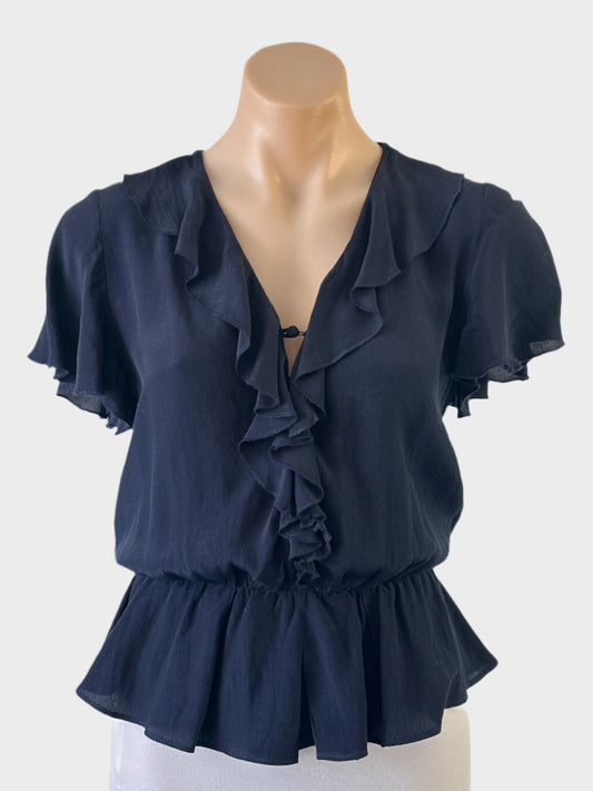 Peplum top with half button-up front, rouleau button loops, ruffle trim with overlock edging, and flutter sleeves, for business or smart casual wear.