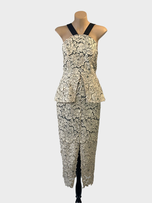 Premonition backless gown in beige with floral appliqué and front split for formal or evening wear.